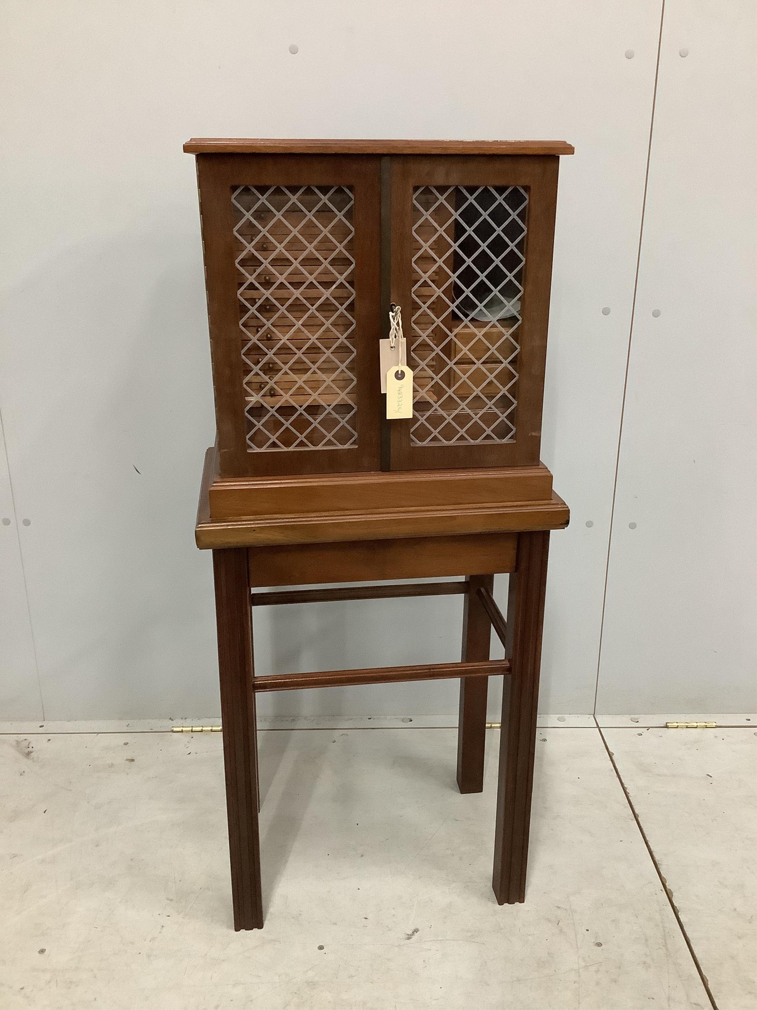 A modern mahogany coin collector's cabinet on stand